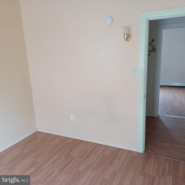 617 Oak St, Allentown, PA 18102 - empty room with wood finished floors, baseboards, baseboard heating, and a smoke detector