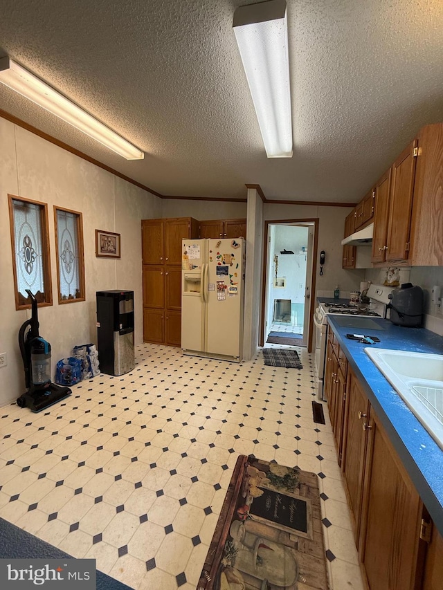 205 Jacob Dr, Moorefield, WV 26836 - kitchen with white appliances, a textured ceiling, brown cabinets, light flooring, and under cabinet range hood