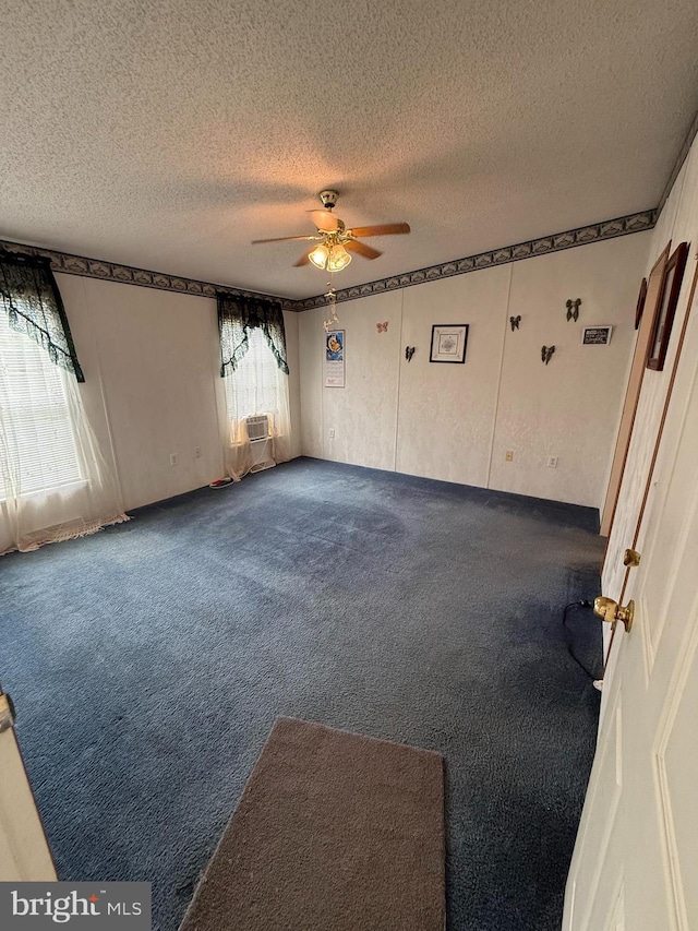 205 Jacob Dr, Moorefield, WV 26836 - spare room featuring a textured ceiling, dark carpet, and ceiling fan