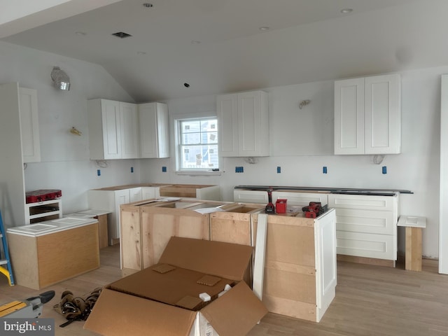 11 E 13th, Long Beach Township, NJ 08008 - kitchen featuring light wood finished floors, white cabinets, and vaulted ceiling