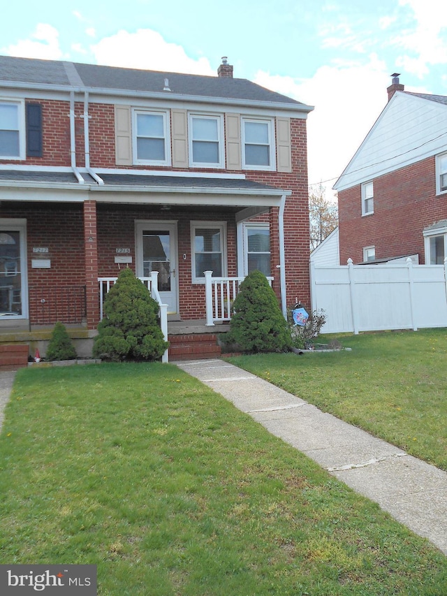 7215 Conley St, Baltimore, MD 21224 - view of property featuring brick siding, a porch, and a chimney