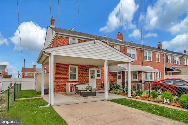 7215 Conley St, Baltimore, MD 21224 - rear view of house featuring brick siding, outdoor lounge area, a chimney, a patio area, and cooling unit