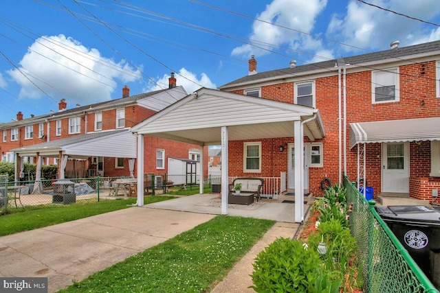 7215 Conley St, Baltimore, MD 21224 - back of house featuring brick siding and an outdoor living space