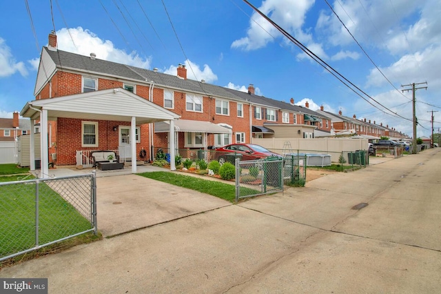7215 Conley St, Baltimore, MD 21224 - rear view of house with brick siding, a gate, a residential view, and a chimney