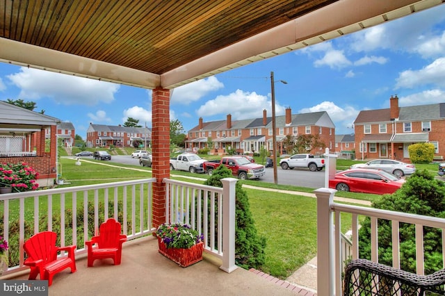 7215 Conley St, Baltimore, MD 21224 - porch featuring a residential view and a lawn