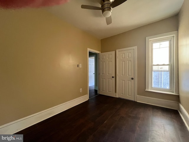 27 N 51st St, Philadelphia, PA 19139 - unfurnished bedroom with dark wood-style floors, baseboards, and a ceiling fan