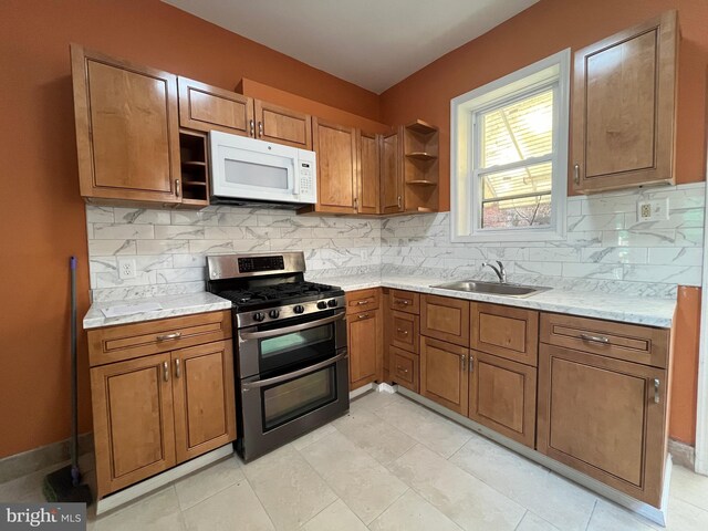 27 N 51st St, Philadelphia, PA 19139 - kitchen featuring range with two ovens, white microwave, a sink, brown cabinets, and open shelves