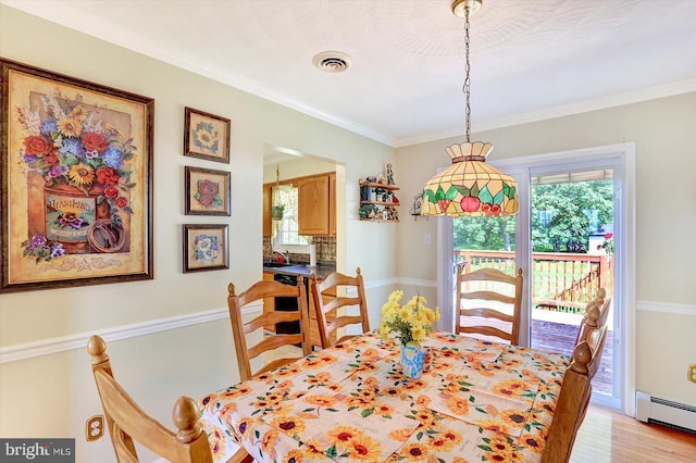 3476 Messersmith Rd, York, PA 17408 - dining area featuring a baseboard heating unit, healthy amount of natural light, light wood-style flooring, and ornamental molding