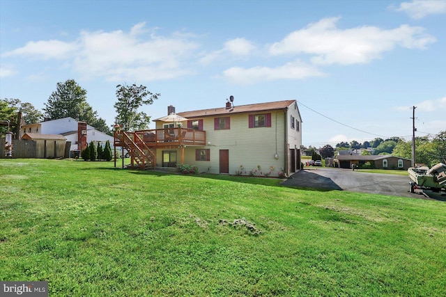 3476 Messersmith Rd, York, PA 17408 - rear view of house with stairway, a deck, a lawn, and asphalt driveway
