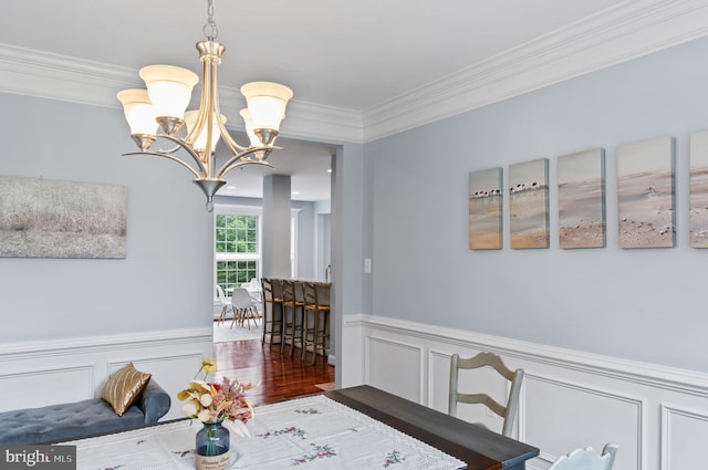 4300 Mountain Laurel Way, Brandywine, MD 20613 - dining area featuring a chandelier, a wainscoted wall, ornamental molding, and a decorative wall