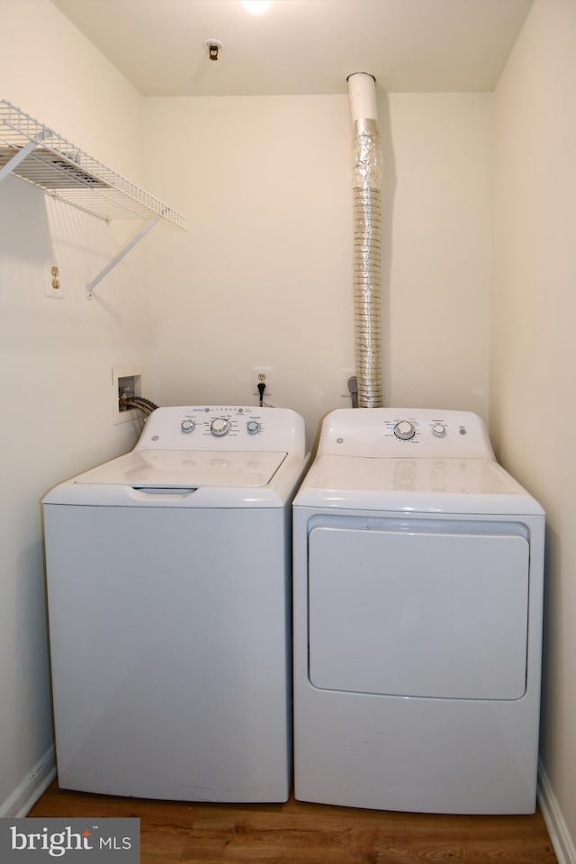 1031 Gardenview Loop Unit 103, Woodbridge, VA 22191 - washroom with washing machine and dryer and wood finished floors