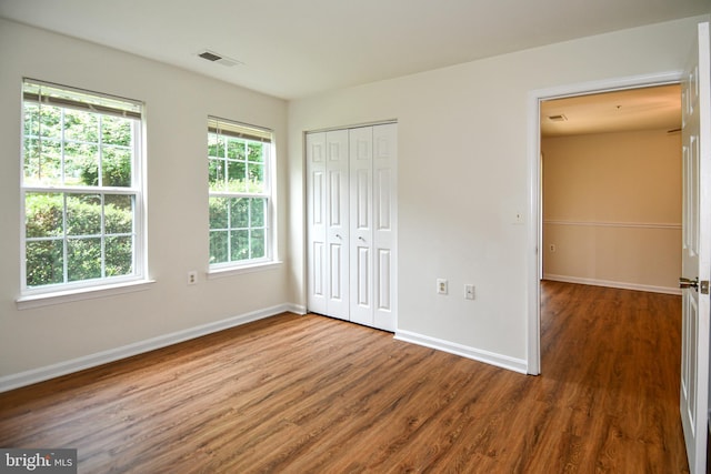1031 Gardenview Loop Unit 103, Woodbridge, VA 22191 - unfurnished bedroom featuring wood finished floors and a closet