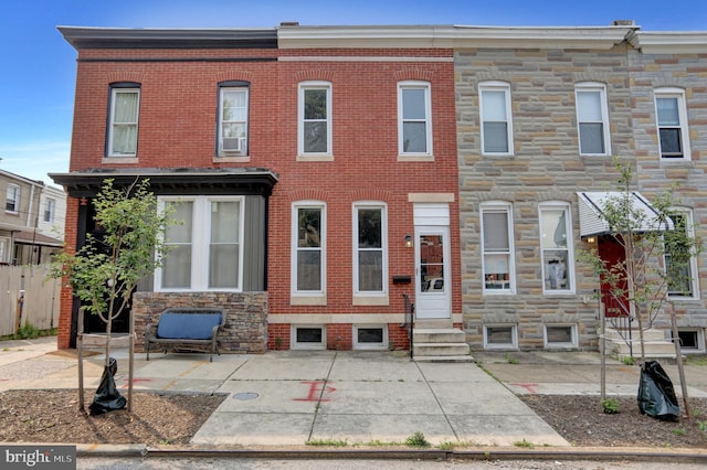 503 W 27th St, Baltimore, MD 21211 - view of property with entry steps, stone siding, and a patio