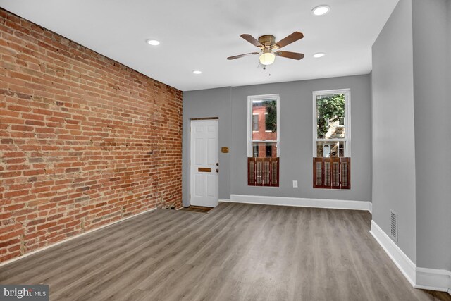 503 W 27th St, Baltimore, MD 21211 - unfurnished living room featuring brick wall, a ceiling fan, baseboards, wood finished floors, and recessed lighting