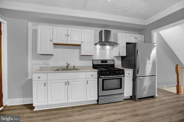 503 W 27th St, Baltimore, MD 21211 - kitchen with stainless steel appliances, a sink, wall chimney exhaust hood, white cabinets, and backsplash