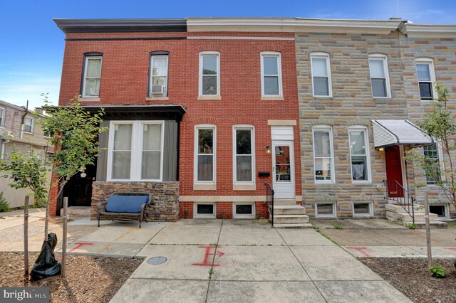 503 W 27th St, Baltimore, MD 21211 - view of property featuring entry steps, brick siding, and stone siding