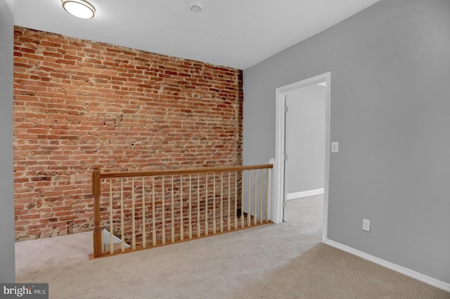 503 W 27th St, Baltimore, MD 21211 - carpeted spare room with brick wall, a smoke detector, and baseboards