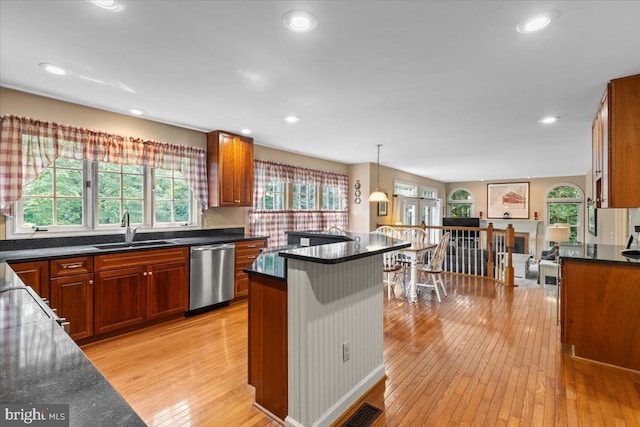 1381 Sunwood Ter, Annapolis, MD 21409 - kitchen with stainless steel dishwasher, a sink, light wood finished floors, a breakfast bar area, and recessed lighting