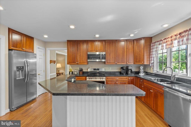 1381 Sunwood Ter, Annapolis, MD 21409 - kitchen with appliances with stainless steel finishes, a sink, light wood-type flooring, recessed lighting, and a kitchen island