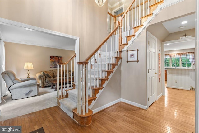 1381 Sunwood Ter, Annapolis, MD 21409 - stairs with hardwood / wood-style floors, baseboards, crown molding, and a high ceiling
