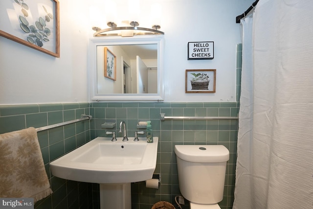 7900 Old York Rd Unit 704-B, Elkins Park, PA 19027 - bathroom featuring tile walls, a wainscoted wall, and a shower with shower curtain