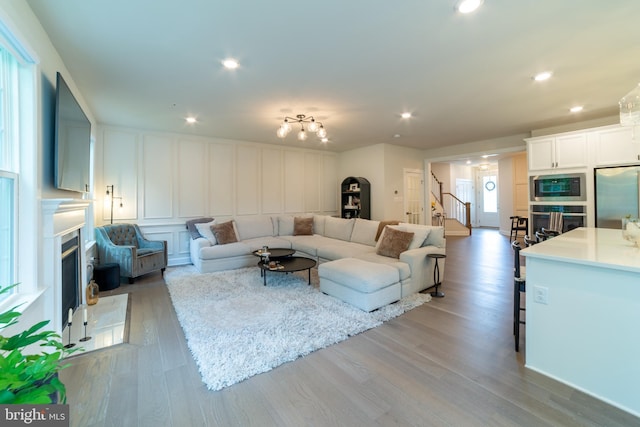 233 W Ponds Edge Dr, Media, PA 19063 - living area with a fireplace, a decorative wall, stairway, light wood-type flooring, and recessed lighting