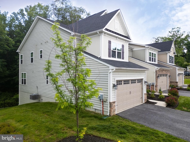 233 W Ponds Edge Dr, Media, PA 19063 - view of side of home featuring a garage, driveway, stone siding, a lawn, and board and batten siding
