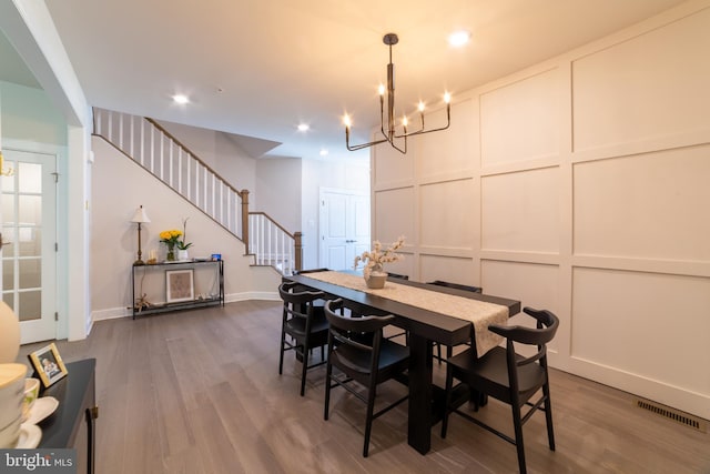233 W Ponds Edge Dr, Media, PA 19063 - dining area featuring a decorative wall, stairway, a chandelier, wood finished floors, and baseboards