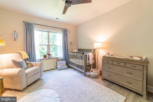 233 W Ponds Edge Dr, Media, PA 19063 - bedroom featuring wood finished floors, a nursery area, and ceiling fan
