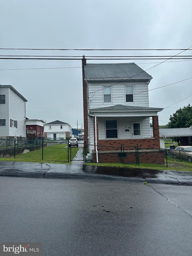 409 S Balliet St, Frackville, PA 17931 - view of front of home featuring brick siding, a gate, a fenced front yard, and covered porch