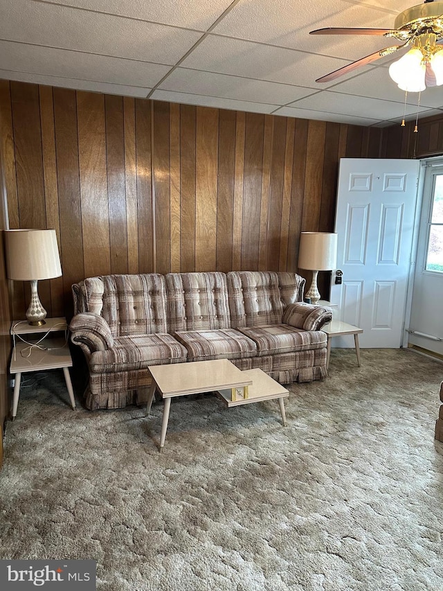 409 S Balliet St, Frackville, PA 17931 - living area featuring wooden walls, carpet, and ceiling fan