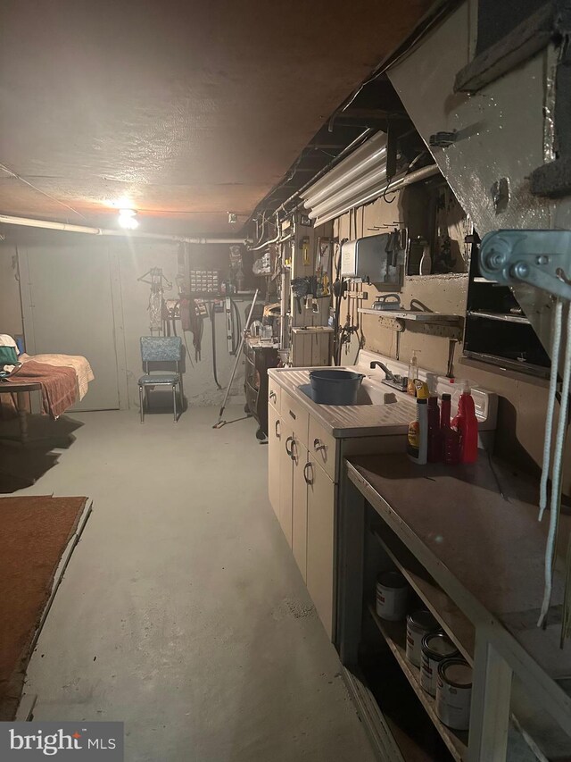409 S Balliet St, Frackville, PA 17931 - unfinished basement featuring a sink and a workshop area