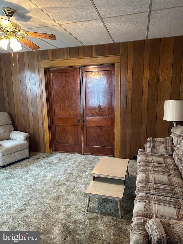 409 S Balliet St, Frackville, PA 17931 - living area with wooden walls, carpet, and a ceiling fan