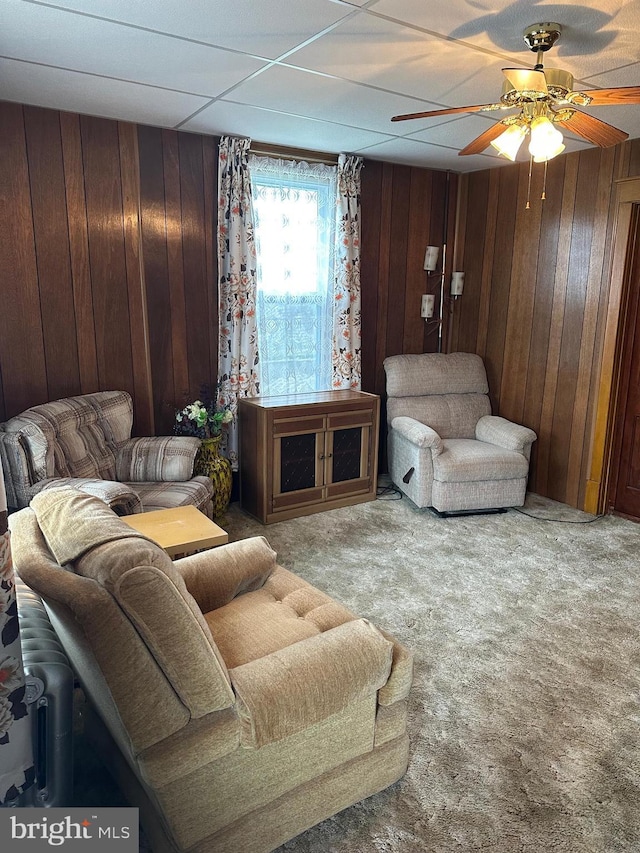 409 S Balliet St, Frackville, PA 17931 - living area with carpet flooring, wood walls, and ceiling fan