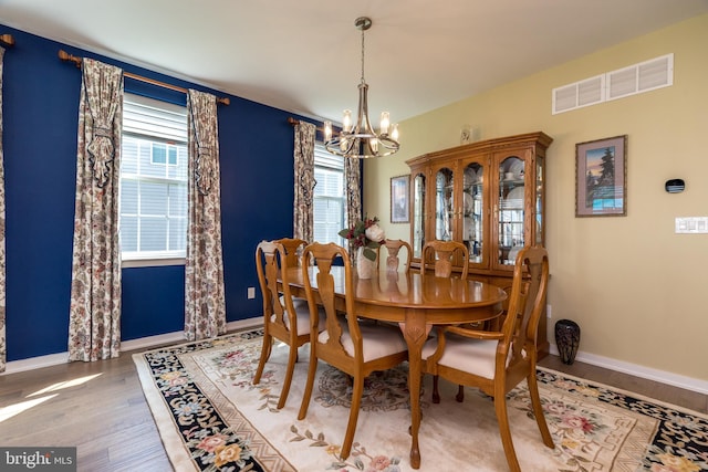 2038 Morgan Creek Dr, Quakertown, PA 18951 - dining area with a chandelier, light wood-style floors, and baseboards