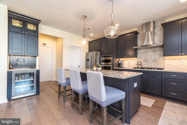 2038 Morgan Creek Dr, Quakertown, PA 18951 - kitchen featuring beverage cooler, wall chimney exhaust hood, appliances with stainless steel finishes, a breakfast bar area, and wood finished floors