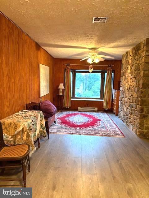 425 Beechcroft Rd, Winchester, VA 22601 - interior space featuring a textured ceiling, hardwood / wood-style floors, wooden walls, and a wall mounted AC