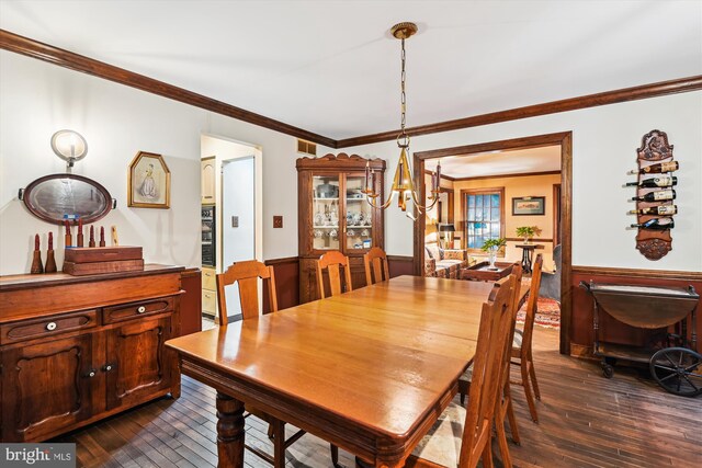 2317 Nancarles Dr, Gambrills, MD 21054 - dining room with a chandelier, a wainscoted wall, dark wood finished floors, and crown molding