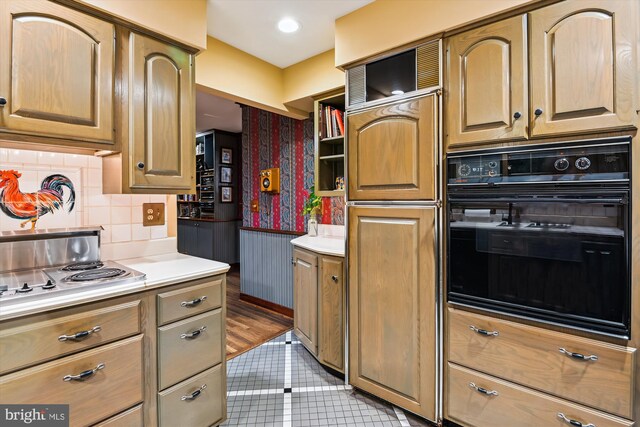 2317 Nancarles Dr, Gambrills, MD 21054 - kitchen featuring black oven, paneled refrigerator, stainless steel electric stovetop, decorative backsplash, and light tile patterned floors