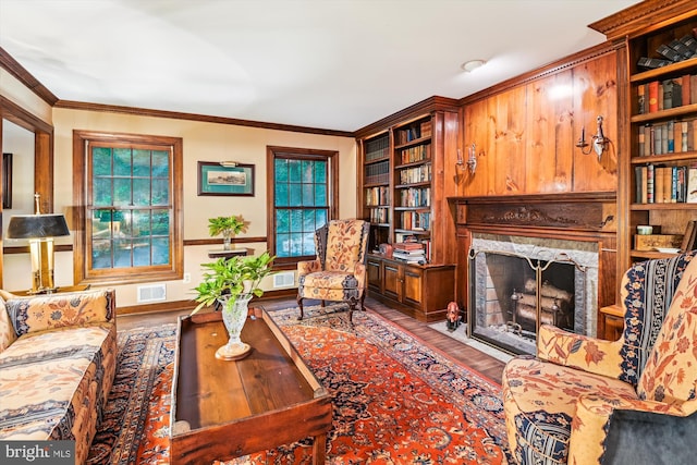 2317 Nancarles Dr, Gambrills, MD 21054 - living area with wood finished floors, a premium fireplace, plenty of natural light, built in features, and crown molding
