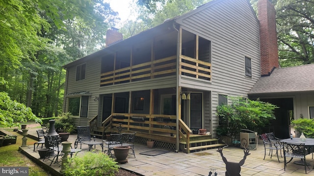 2317 Nancarles Dr, Gambrills, MD 21054 - rear view of house with a chimney, a patio area, a balcony, a sunroom, and outdoor dining space