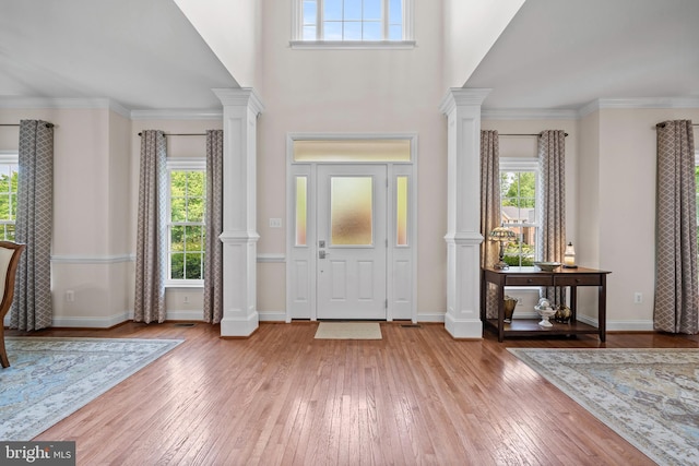 6000 Clairemont Dr, Owings, MD 20736 - entryway featuring hardwood / wood-style flooring, decorative columns, baseboards, and a towering ceiling