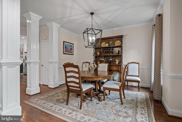6000 Clairemont Dr, Owings, MD 20736 - dining space featuring decorative columns, dark wood-style floors, a chandelier, crown molding, and baseboards