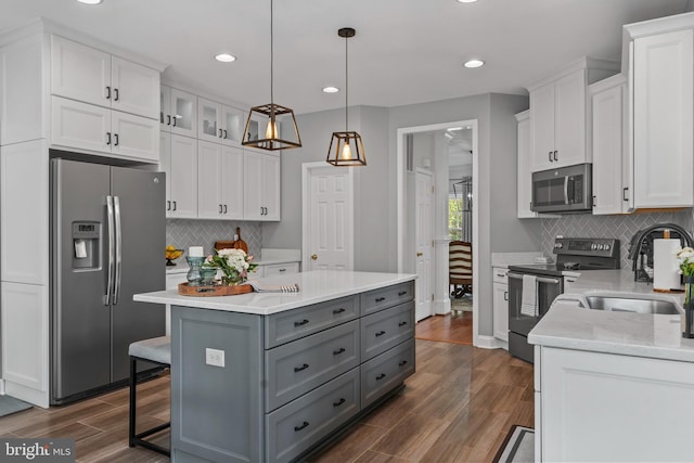 6000 Clairemont Dr, Owings, MD 20736 - kitchen featuring appliances with stainless steel finishes, gray cabinets, a sink, white cabinetry, and a kitchen island