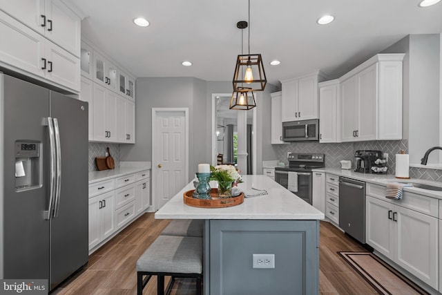 6000 Clairemont Dr, Owings, MD 20736 - kitchen with appliances with stainless steel finishes, white cabinets, tasteful backsplash, recessed lighting, and decorative light fixtures