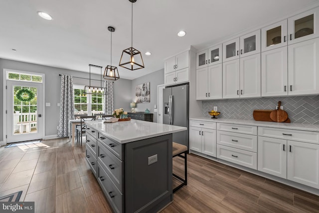 6000 Clairemont Dr, Owings, MD 20736 - kitchen with stainless steel fridge, white cabinetry, light countertops, backsplash, and gray cabinetry
