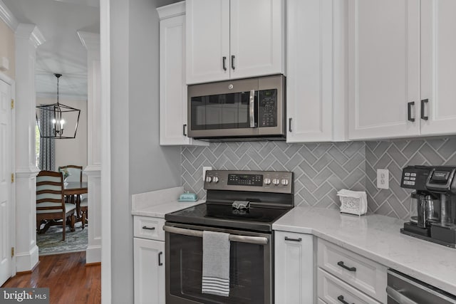 6000 Clairemont Dr, Owings, MD 20736 - kitchen featuring stainless steel appliances, a chandelier, decorative backsplash, white cabinetry, and dark wood-style flooring