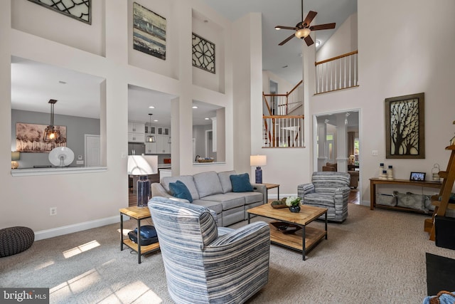 6000 Clairemont Dr, Owings, MD 20736 - living area with carpet flooring, ceiling fan, baseboards, a high ceiling, and stairway