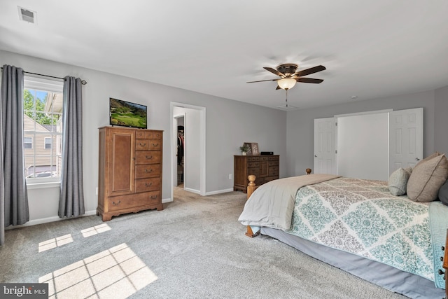 6000 Clairemont Dr, Owings, MD 20736 - bedroom featuring baseboards, a walk in closet, light colored carpet, and a closet