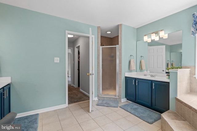 6000 Clairemont Dr, Owings, MD 20736 - bathroom featuring vanity, a shower stall, tile patterned flooring, baseboards, and tiled bath